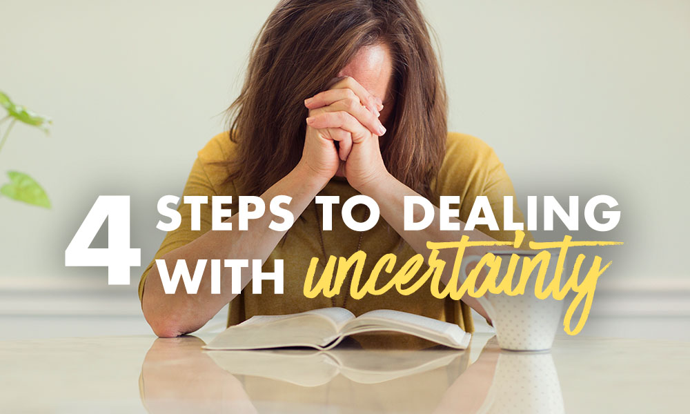 woman praying with Bible open