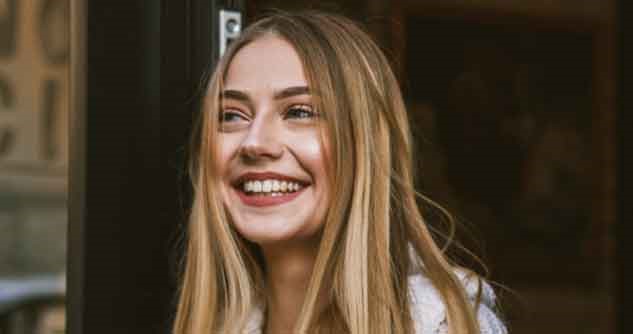 A young long-haired woman smiles