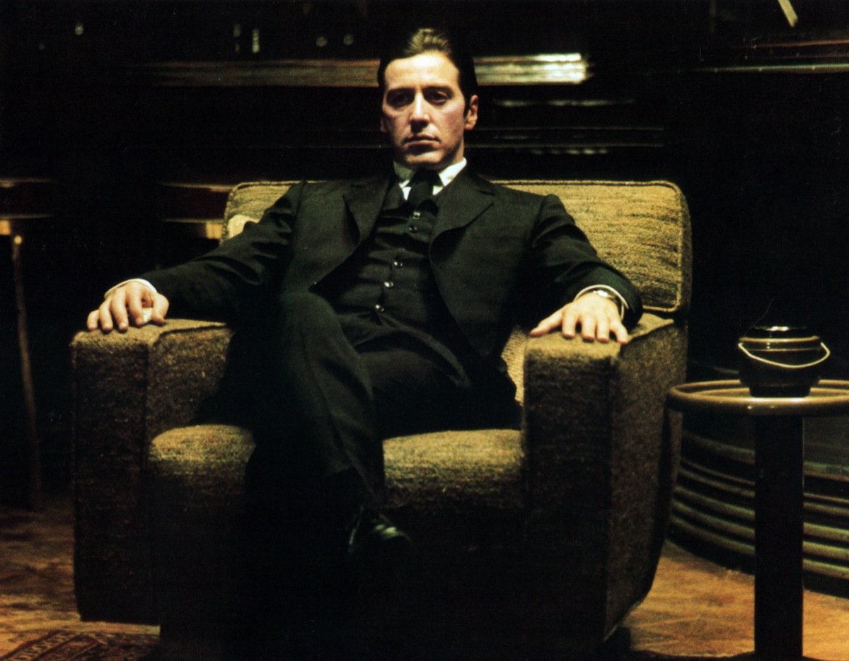 Al Pacino sitting in a large chair.